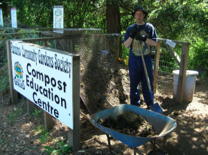 A long time volunteer, Kelly, sifts compost in the compost education centre at the demonstration garden